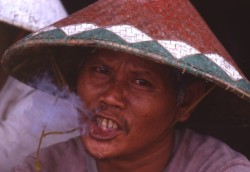 Torajan man smoking clove cigarette in Rontepao